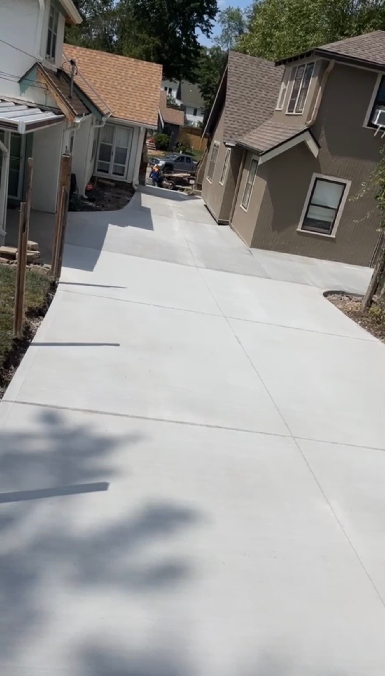 Elevated view of the finished shared driveway showing its full length between both homes