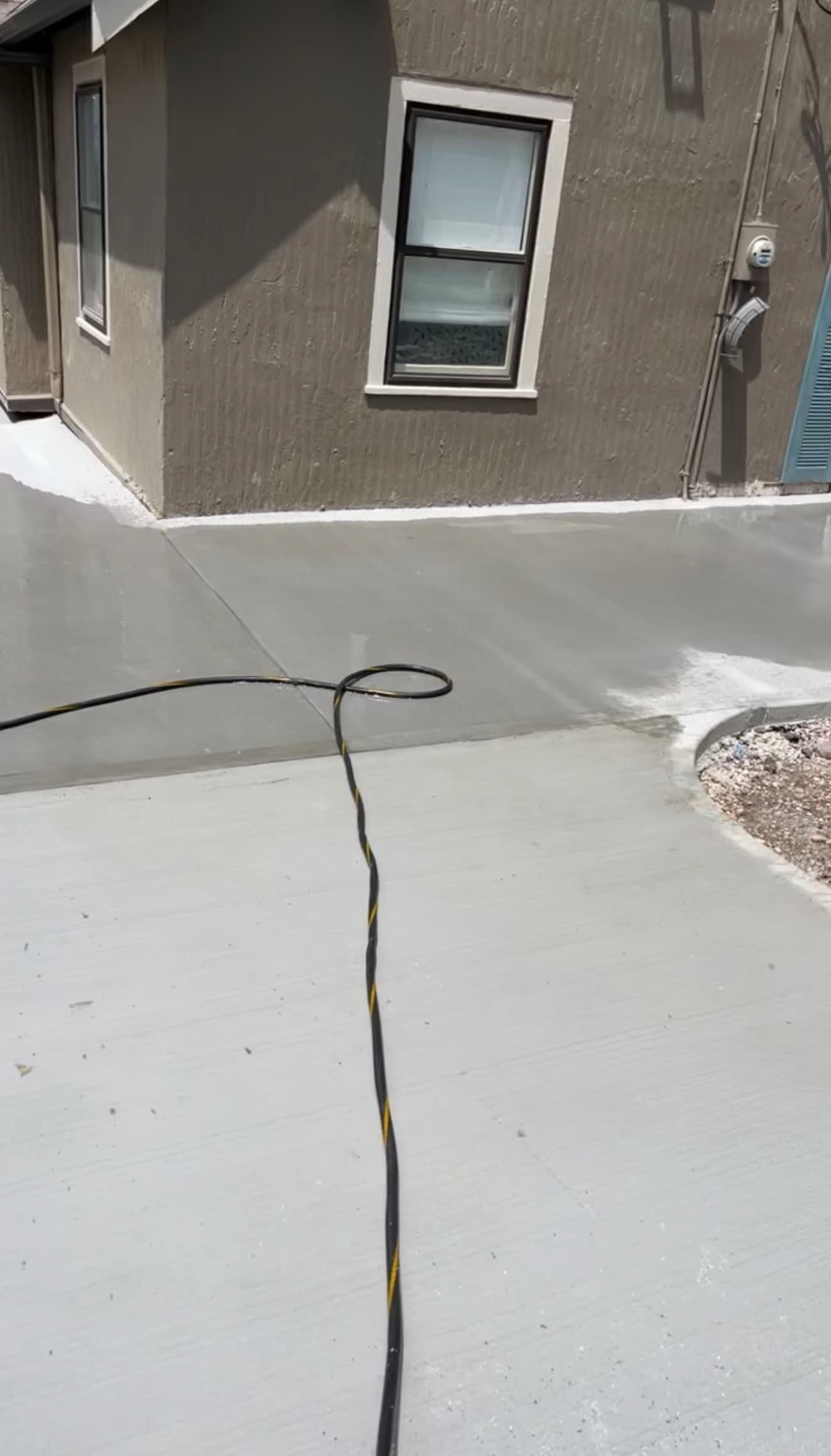 Water further along the finished driveway surface, following the designed path toward the street