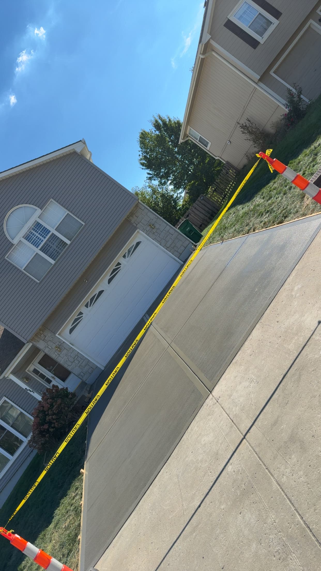 New concrete walkway leading to a townhome garage